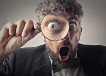 Photo Of Man Holding Magnifying Glass Close To His Eye