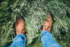 Photo of Man Standing In Thick Grass To Show Uneven Terrain