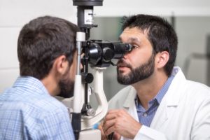 Man Having His Eyes Examined By Optician